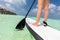 Woman does stand up paddle boarding on the ocean in Maldives