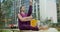 Woman does stretching and yoga exercices for legs on the bench in the yard of an apartment building, fitness in the