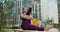 Woman does stretching and yoga exercices for legs on the bench in the yard of an apartment building, fitness in the