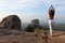 Woman does yoga on a rock formation somewhere in Sri Lanka