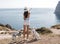 Woman with a dog dalmatian. Girl and her friend dog on the blue sea background