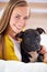 Woman, dog and happy in living room in portrait, smile for pet love and bonding at home with domestic canine. Relax
