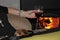 Woman with dog in her lap holding a glass of red wine in front of a wood fireplace - selective focus