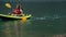 Woman with dog in the kayak on the lake trip