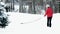 Woman and dog in matching red jackets walking in snow after winter storm in Minnesota