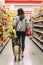 Woman and a dog in a pet food store between shelves