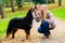 Woman and dog at retrieving stick game