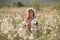 Woman dogs meadow chamomile. Woman embraces her furry friends in a serene chamomile field, surrounded by lush greenery