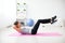 Woman doing abdominal crunches pilates exercise on