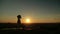 Woman doing Ashtanga yoga in the park at sunset