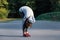 Woman doing beginner yoga excercise for stretching at park. Female person stretching before jogging outdoors