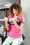 Woman doing biceps workout with exercising machine