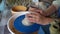 Woman doing ceramics pot vessel on pottering wheel. Traditional cultural crafts of indigenous people, cultural heritage