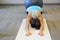 Woman doing childs pose in yoga class in fitness studio