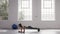 Woman doing elbow plank holds at fitness studio