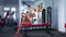 Woman doing exercise with barbell in the gym.