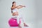 Woman doing exercises with dumbbells on a fitness ball