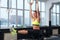 Woman doing exercises with rings, hanging, pulling legs up, ABS training.