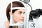 Woman doing eyesight measurement with optical slit lamp
