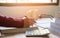 Woman doing finances and calculating on table  at home office.Concept finances and economy with book in morning