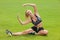 Woman doing fitness stretch exercise outdoor