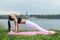 Woman doing Hatha yoga asana Purvottanasana plank pose outdoors.