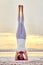 Woman doing Hatha yoga headstand or Sirsasana on nature