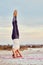 Woman doing Hatha yoga headstand or Sirsasana outdoors