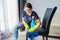 Woman doing house cleaning, female in headphones and gloves with detergent