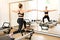 Woman doing lunge stretch while on reformer bed