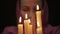Woman doing the magic ritual. close-up several candle. halloween or religion concept