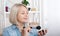 Woman is doing makeup in front of the mirror. Mirror Magic enchanting image showcasing a woman engrossed in her makeup routine,