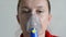 Woman doing medical procedure - respiratory inhalation in mask