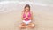 Woman doing meditation near the ocean beach. Yoga silhouette.