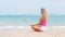 Woman doing meditation near the ocean beach. Yoga silhouette.