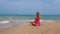 Woman doing meditation near the ocean beach. Yoga silhouette.