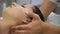 Woman doing neck massage at the reception of the chiropractor. Men`s hands do massage of the cervical spine to an