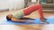 Woman doing pelvic lift abdominal exercise at home