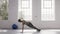 Woman doing plank twist at fitness studio