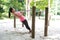 Woman doing pull up on exercise bar in a park