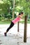 Woman doing push up on bar in outdoor exercise park