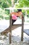 Woman doing push up on bar in outdoor exercise park