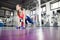 Woman doing pushup exercise with dumbbell in a gym