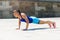 Woman doing pushups outdoor.