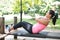 Woman doing sit ups on outdoor exercise park