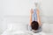 Woman doing some exercise lying in bed with legs high up