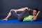 Woman doing strength exercises for abdominal muscles over grey