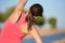 Woman doing stretching exercise for back, sport background.