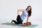 Woman doing stretching exercise, Lizard Pose studio full length