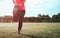 Woman doing stretching exercises for legs.  Athlete woman preparing for running. Low section view of fit young woman stretching